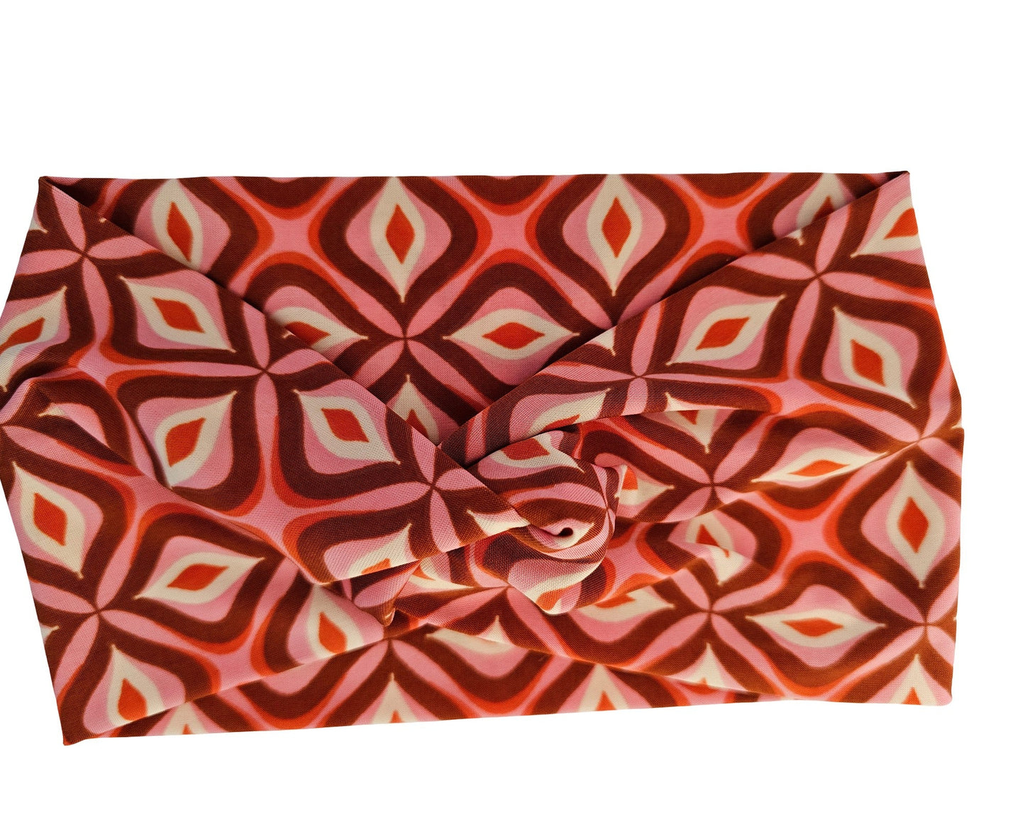 Folded fabric with a red and pink geometric pattern on a white background