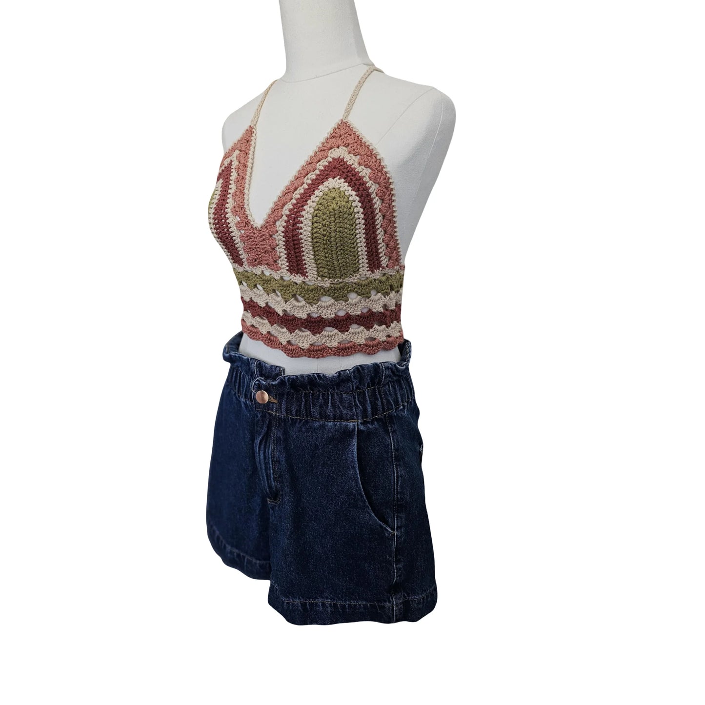 Mannequin wearing a striped sleeveless top and denim shorts on a white background