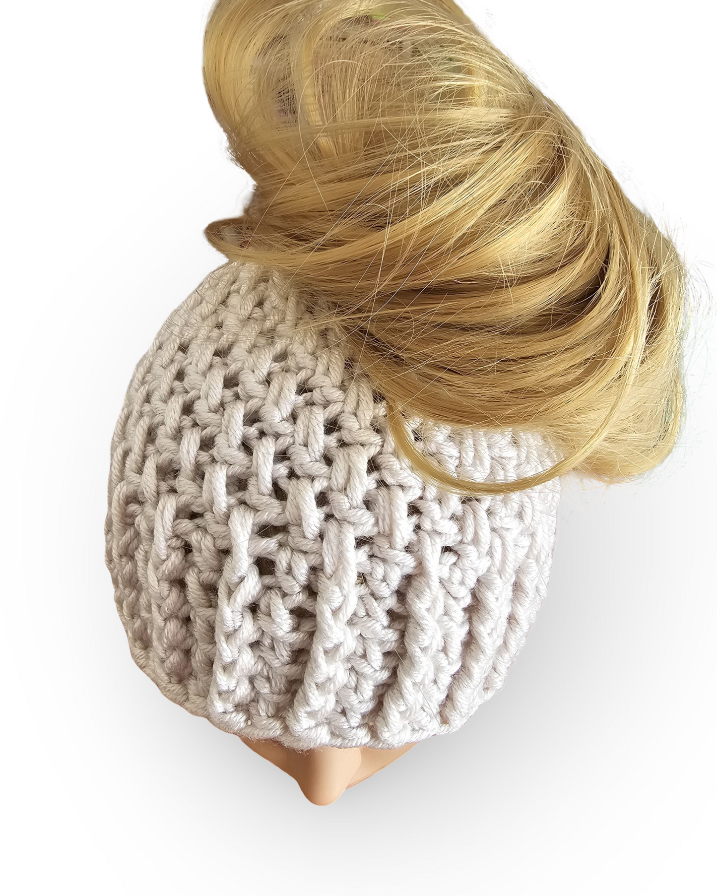 Knitted beige beanie with a blonde hair bun on a mannequin head against a white background