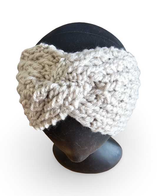 Knitted headband in beige and white on a black mannequin head against a white background