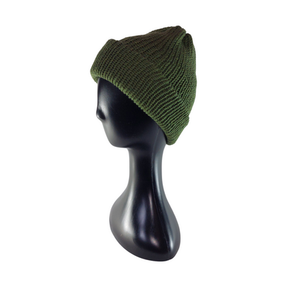 Green knit beanie on a black mannequin head against a white background