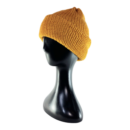 Yellow knit beanie on a black mannequin head against a white background