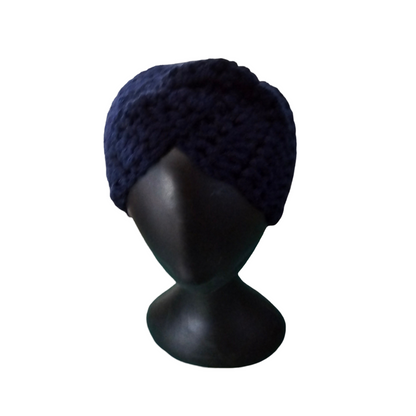 Navy blue knitted turban on a black mannequin head against a white background