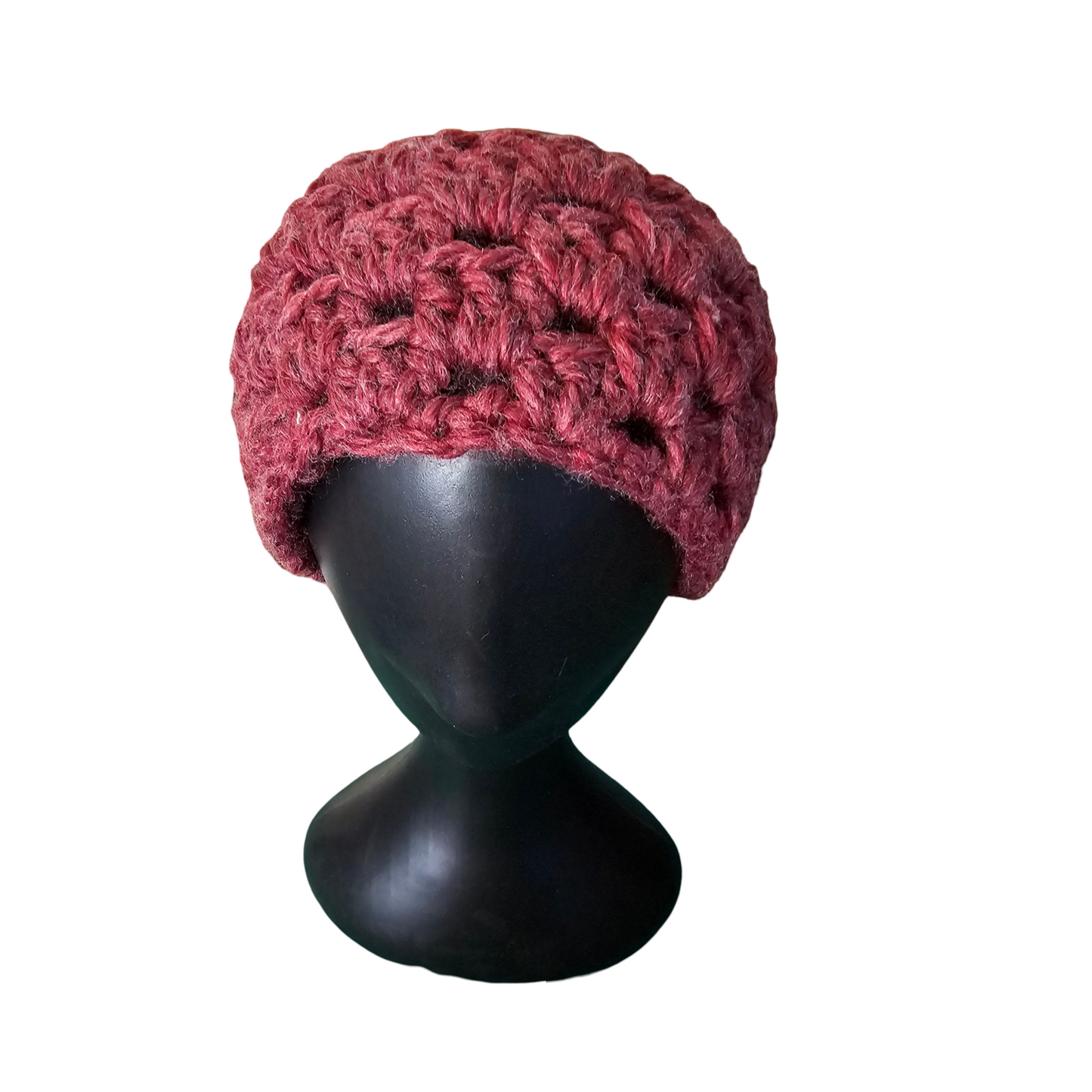 Red knitted beanie on a black mannequin head against a white background