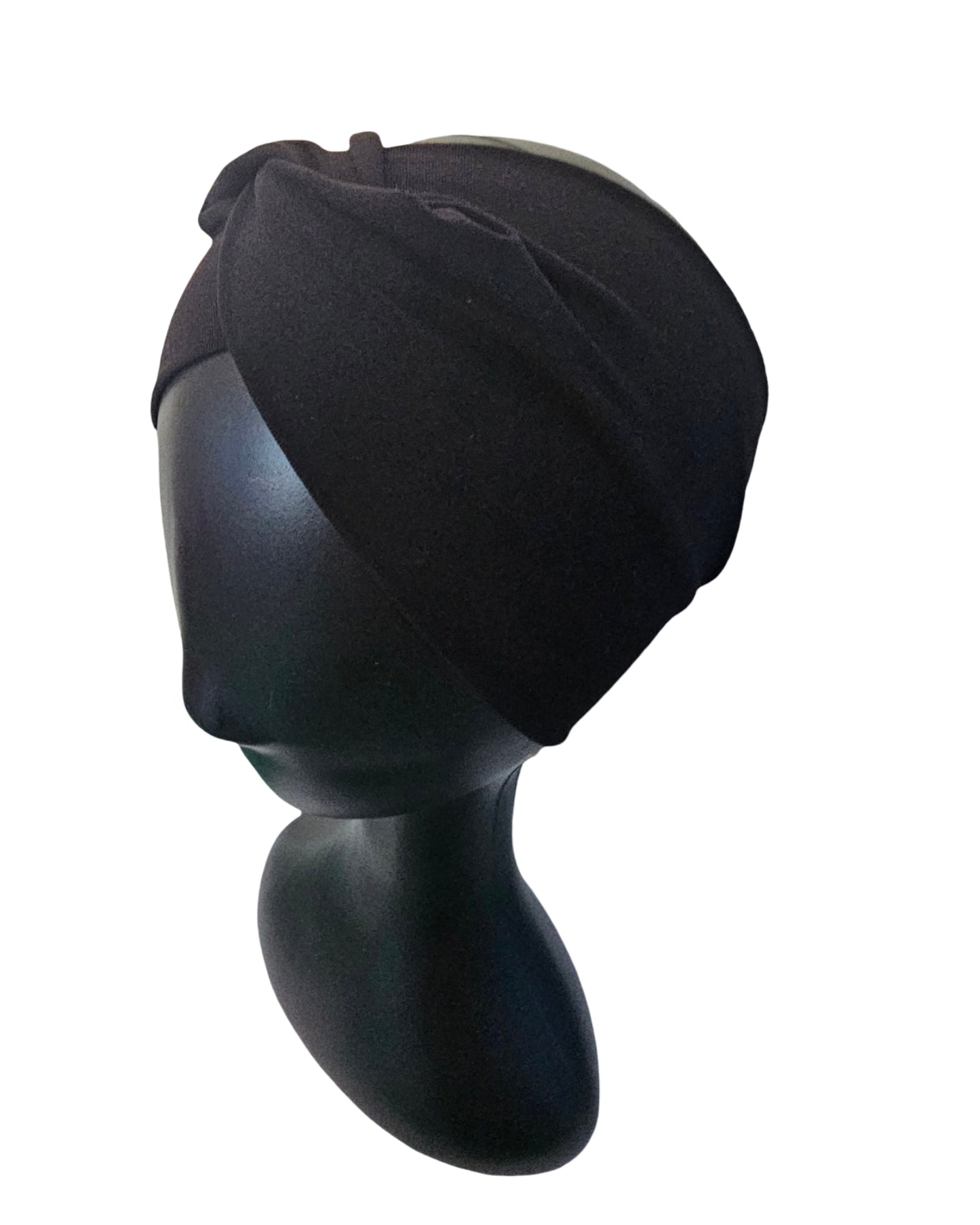 Black turban on a mannequin head against a white background