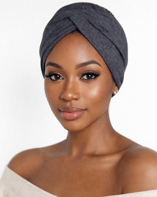 Model wearing a charcoal knotted headband with a white background