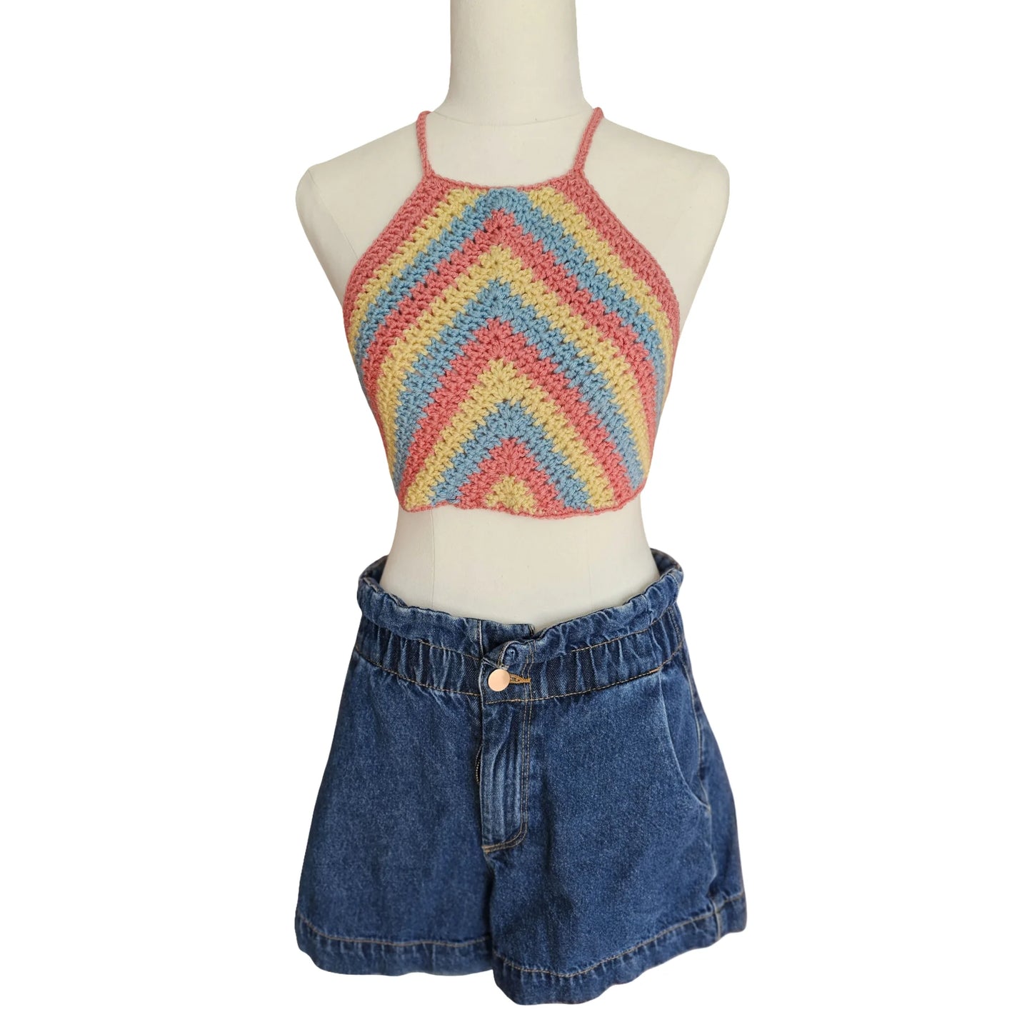 Mannequin wearing a colorful striped crop top and blue denim shorts on a white background