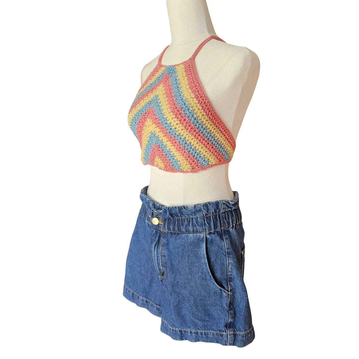 Mannequin wearing a colorful striped crop top and denim skirt on a white background