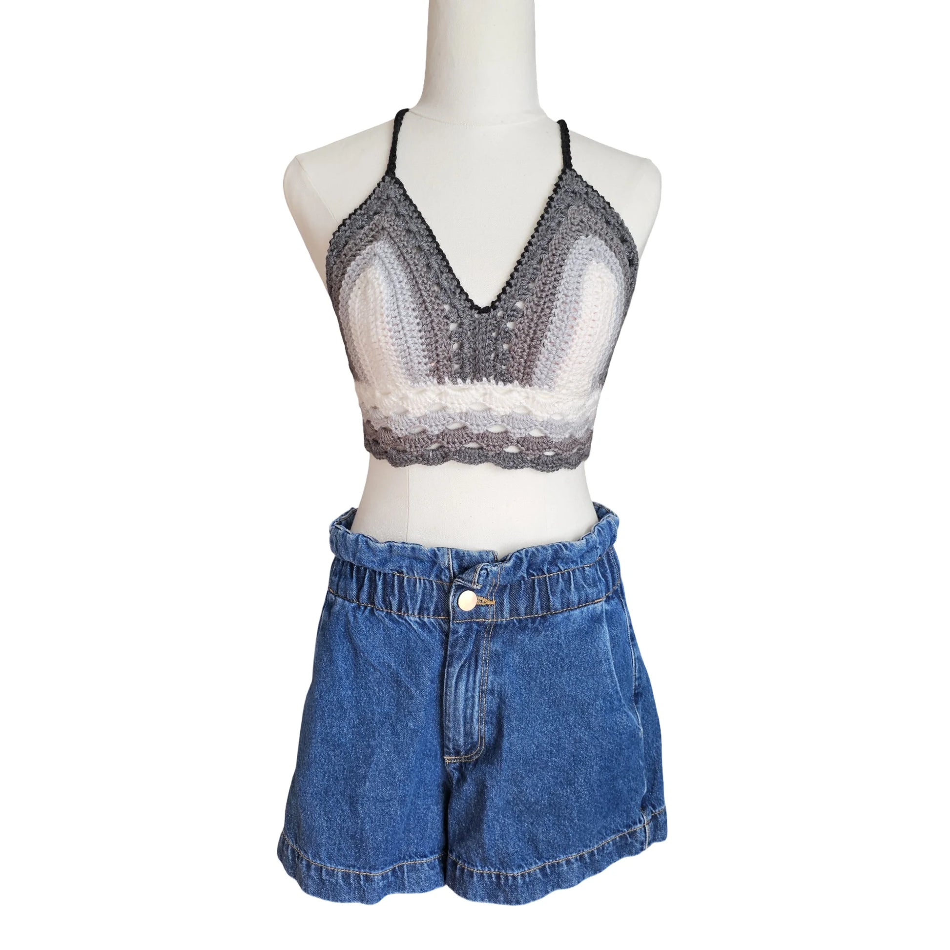 Mannequin wearing a gray crochet  top and blue denim shorts on a white background
