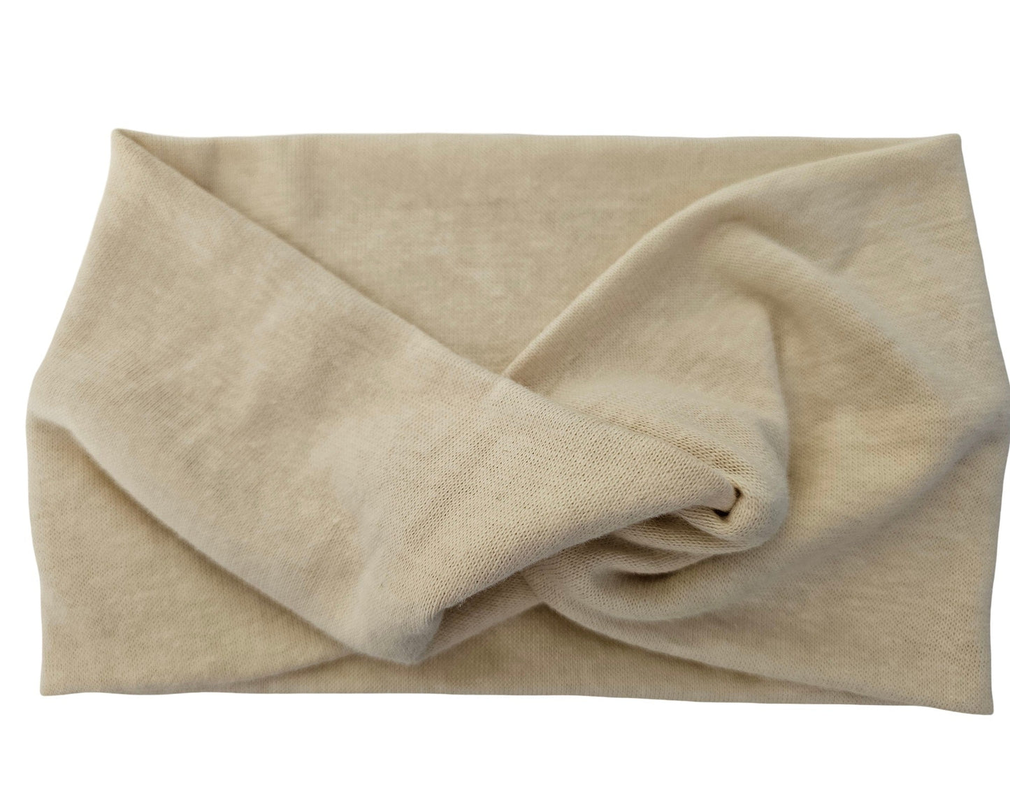 Beige towel folded neatly on a white background