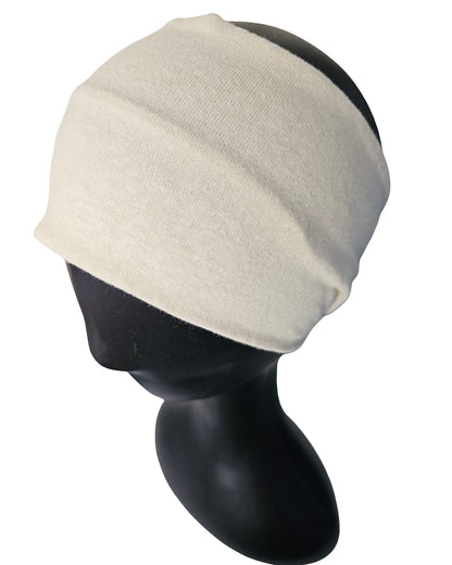 Beige headband on a black mannequin head against a white background