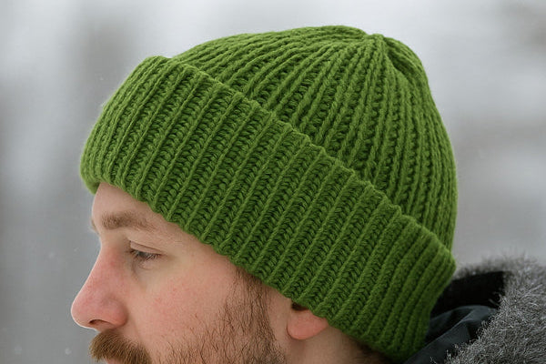 Model wearing a knitted beanie
