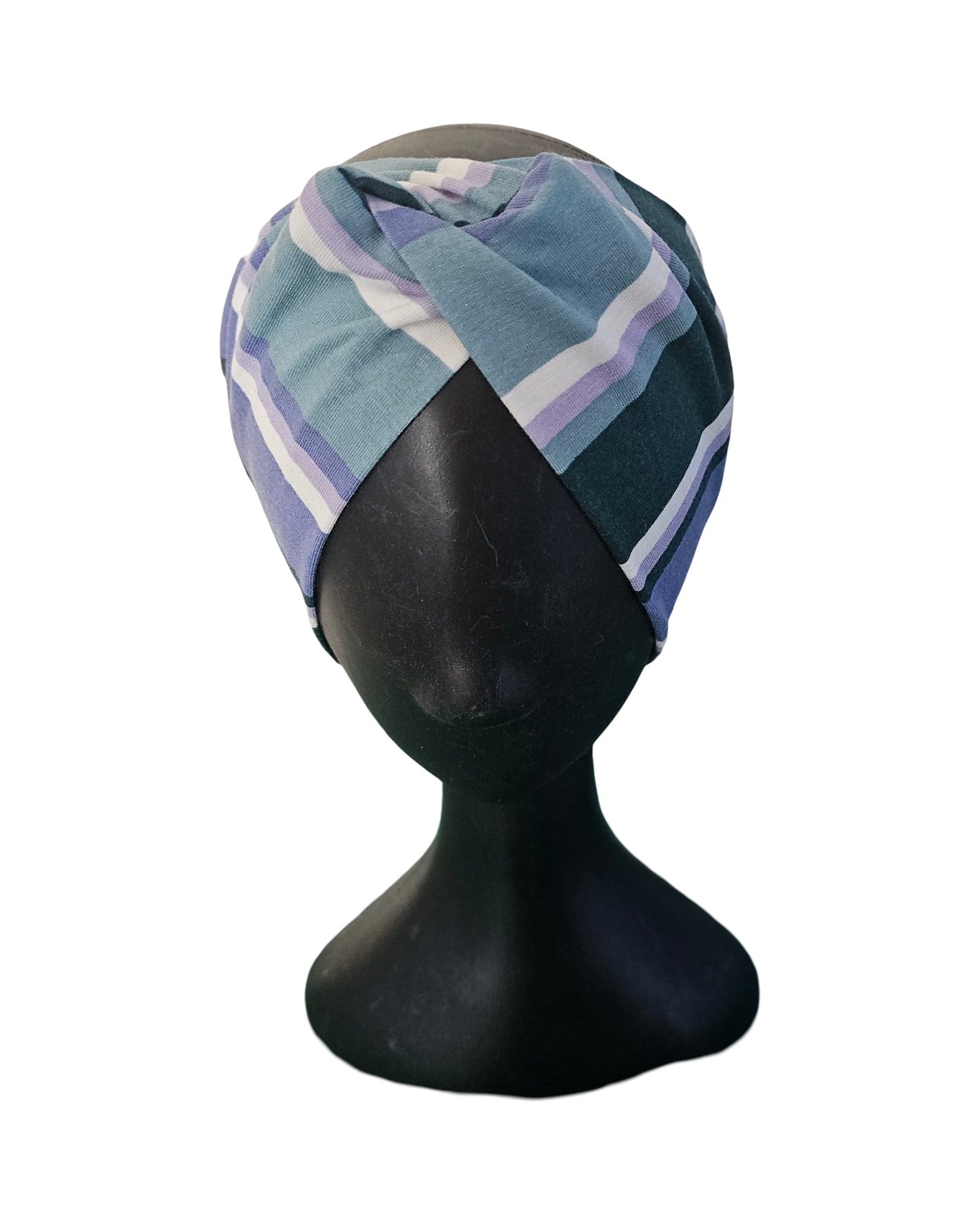 Green and purple patterned headband on a black mannequin head against a white background