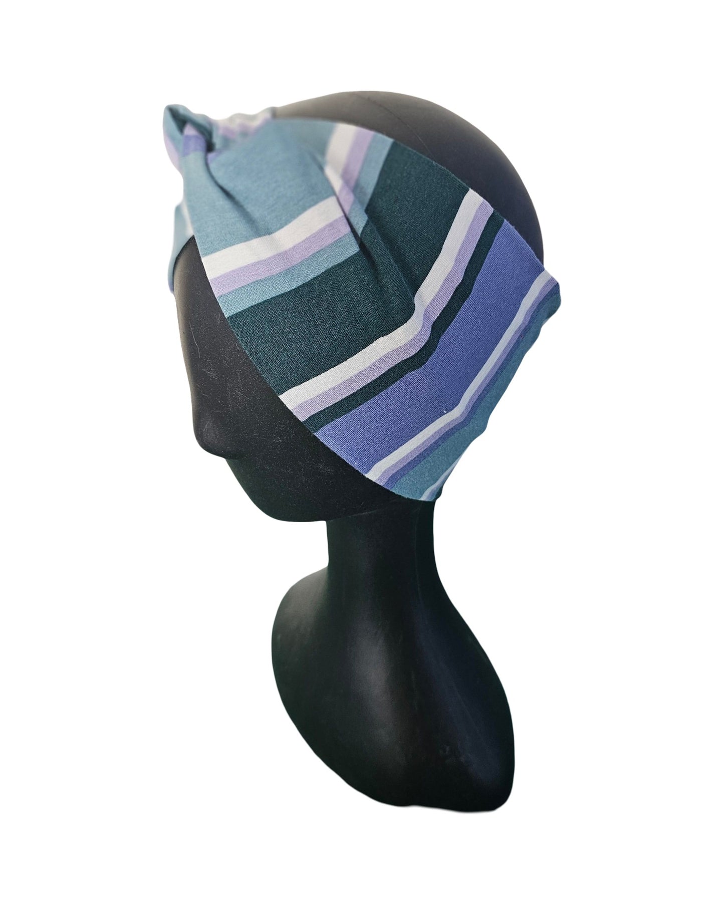 Striped ladies headband on a mannequin head against a white background