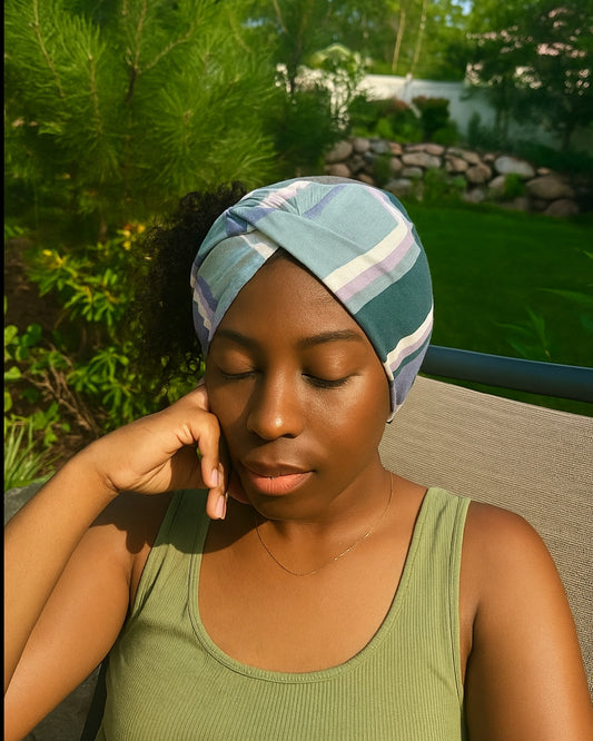 Woman wearing a patterned Knotted headband in a garden setting