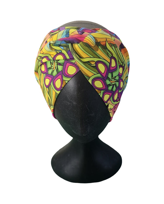 Colorful patterned ladies headband on a black mannequin head against a white background