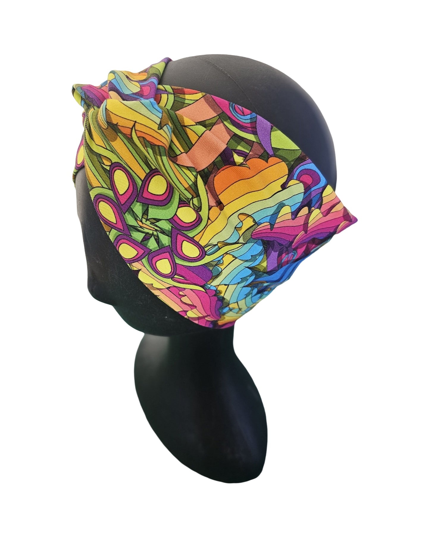 Colorful woman's knotted headband with abstract pattern on a mannequin head against a white background