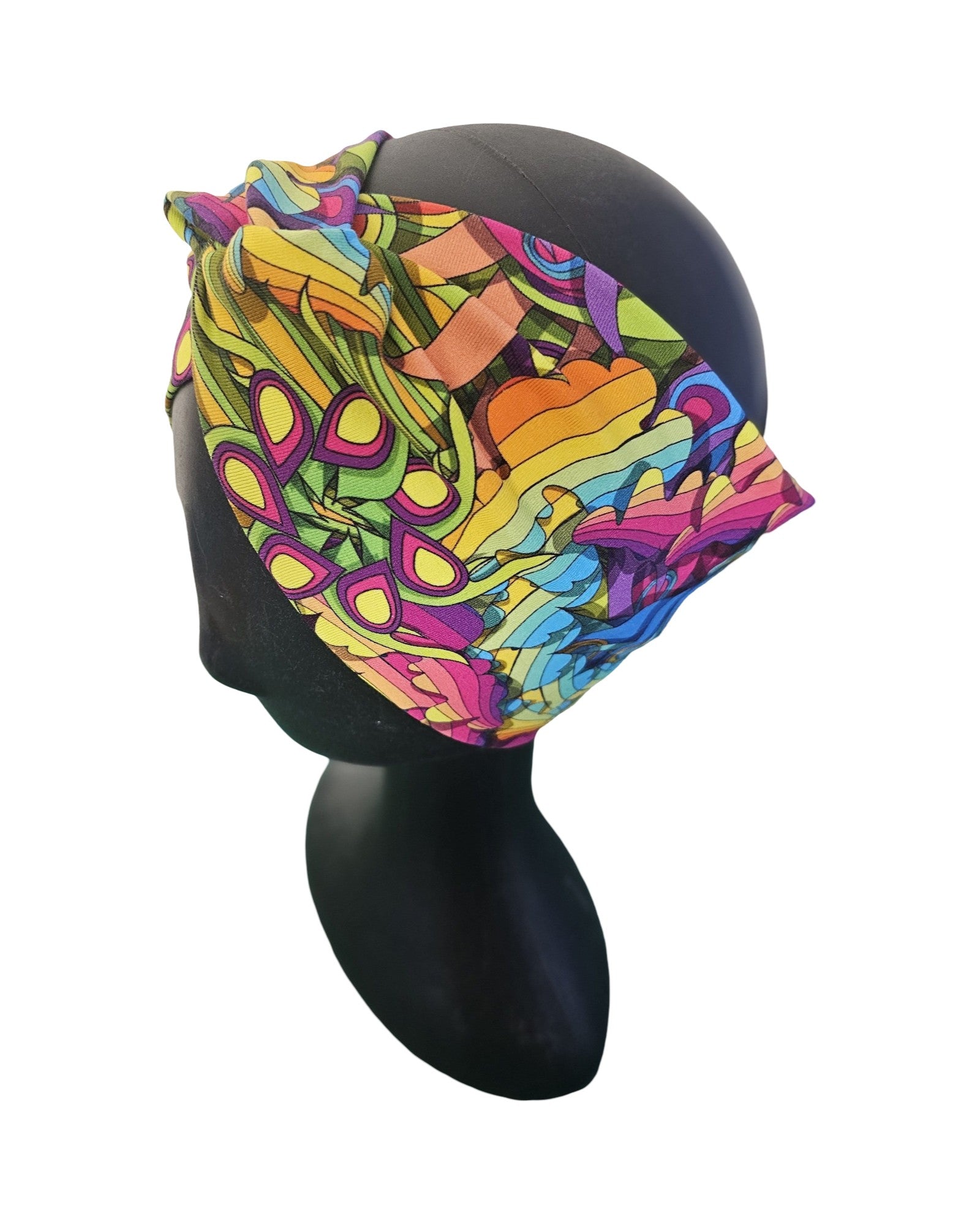 Colorful woman's knotted headband with abstract pattern on a mannequin head against a white background