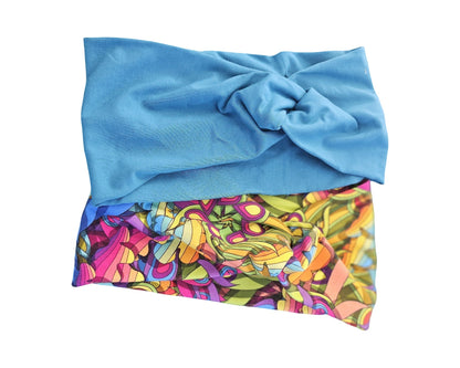 Blue towel with colorful abstract pattern on a white background