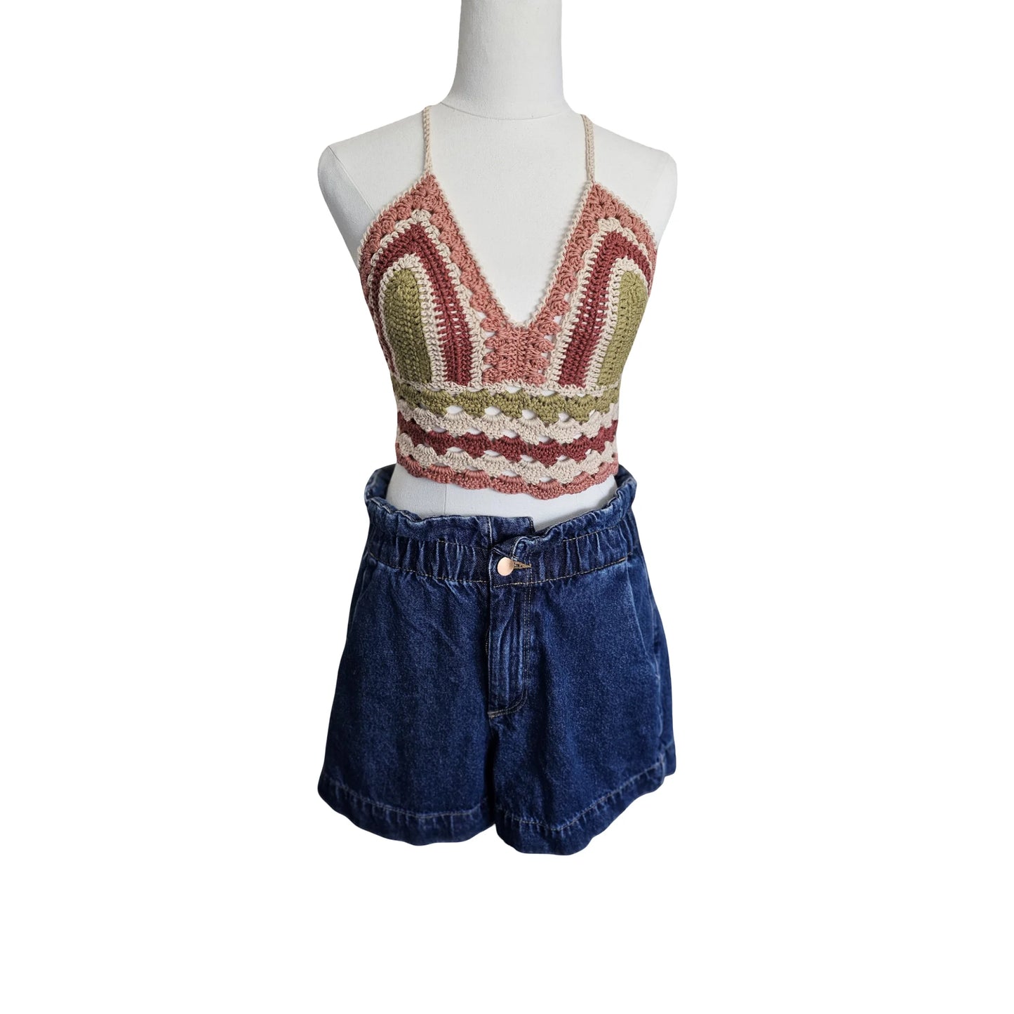 Mannequin wearing a patterned Crochet top and denim shorts on a white background
