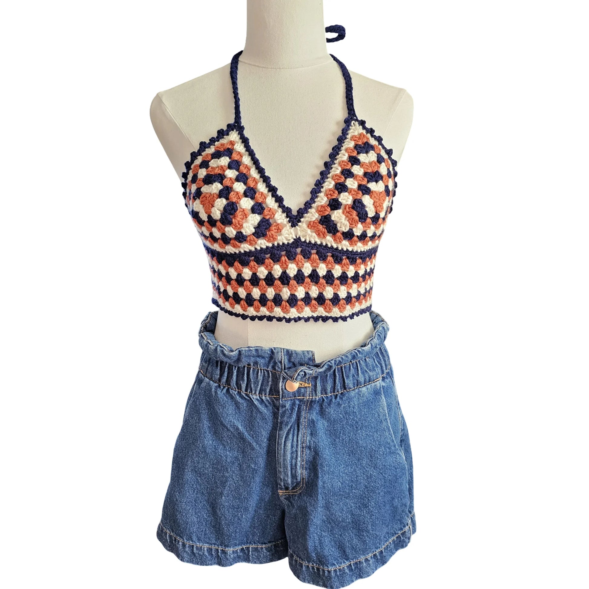 Mannequin show casing crochet top front view with a white background