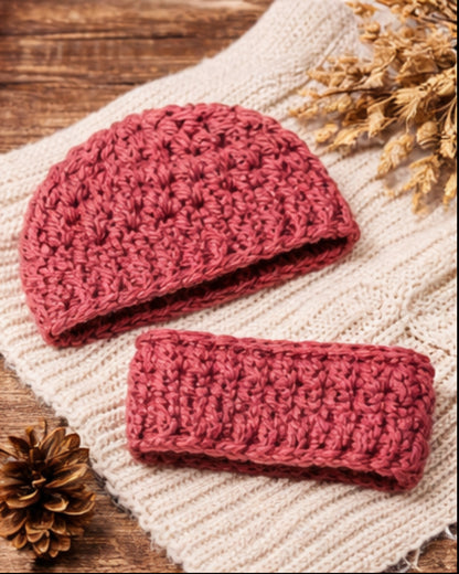 Pink crocheted beanie and headband set on a textured surface with decorative elements.