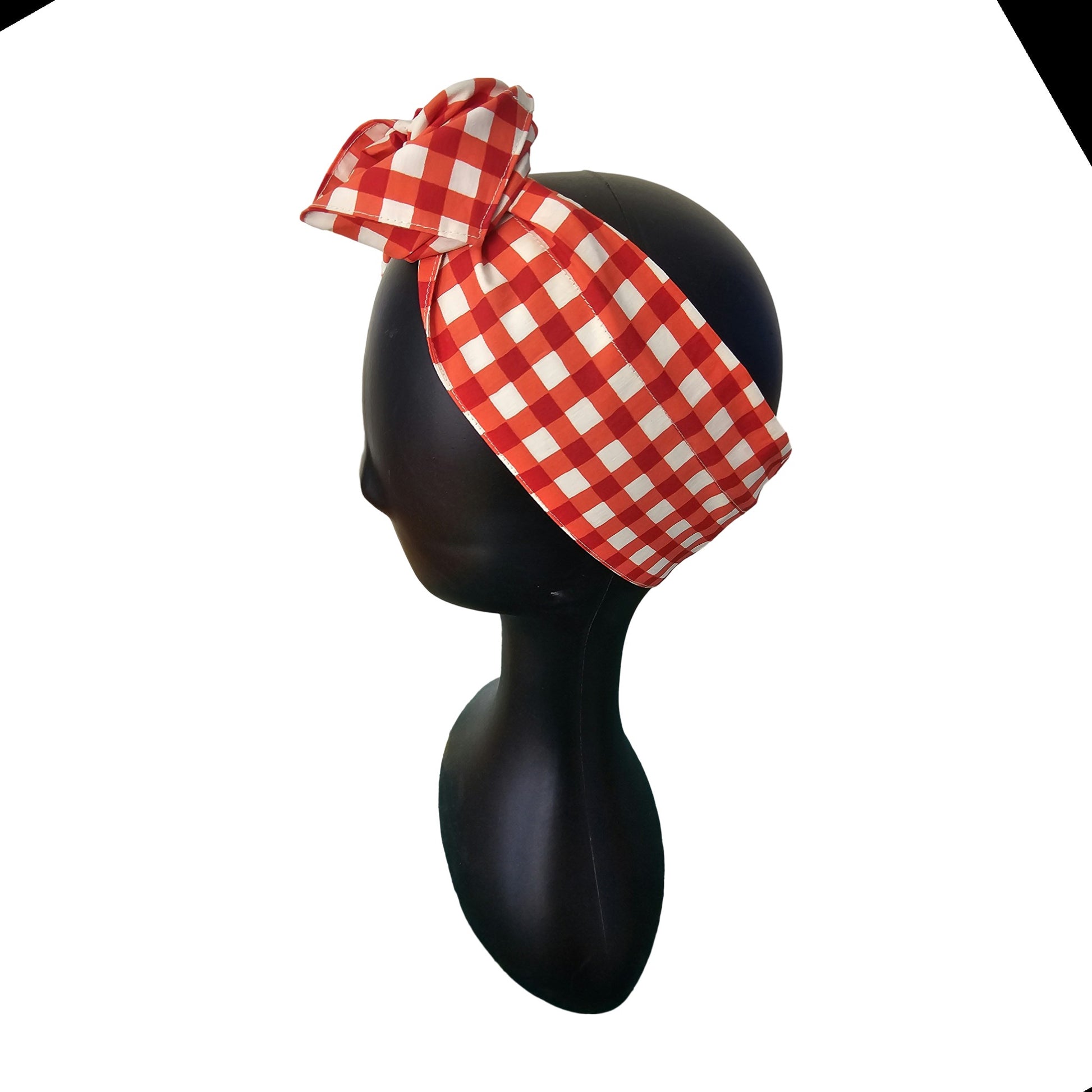 Red and white checkered ladies wire headband on a mannequin head against a white background