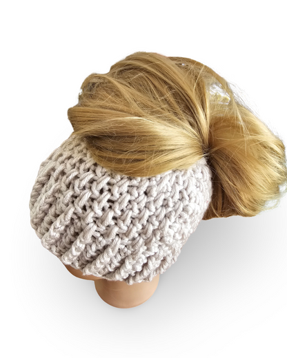 Knitted beige beanie with a blonde ponytail on a mannequin head against a white background